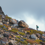 A person hiking up a mountain natural li 512x512 55723412.png